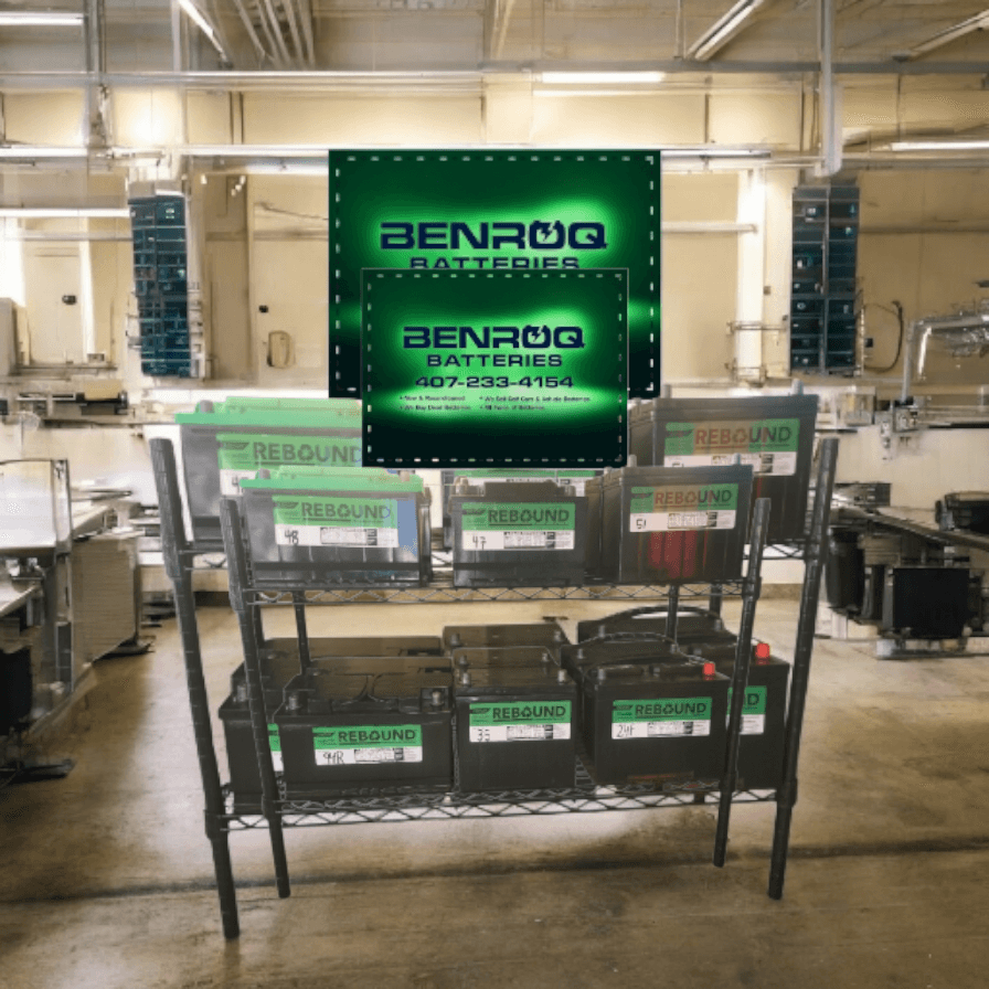 Metal rack holding Rebound car batteries under a glowing green Benroq Batteries company sign.